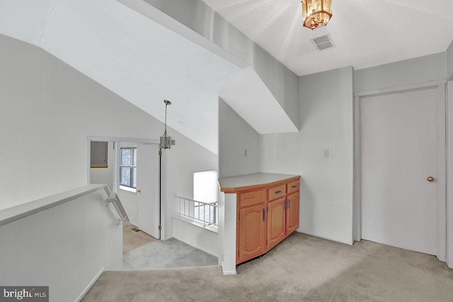 interior space featuring lofted ceiling and light carpet