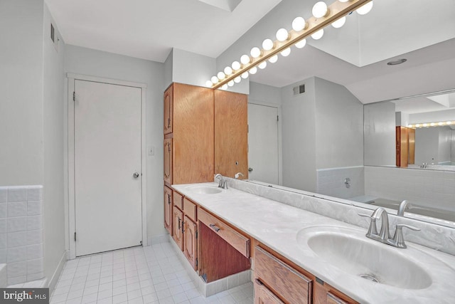 bathroom with tile patterned floors and vanity