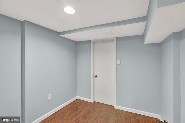 basement with dark hardwood / wood-style floors