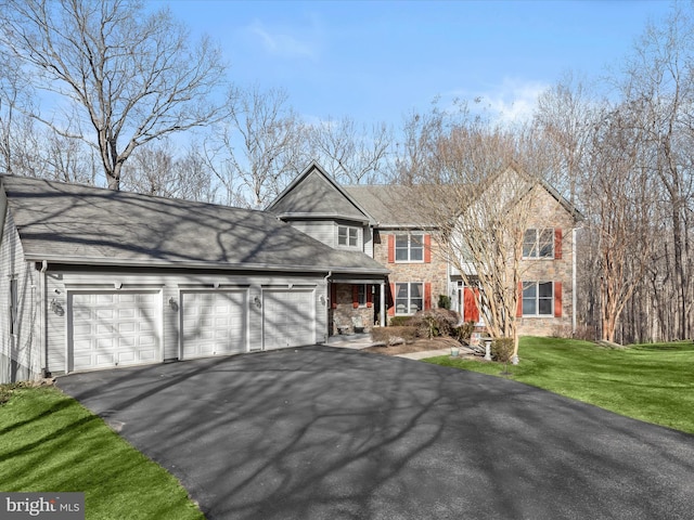 traditional-style house featuring a garage, stone siding, driveway, and a front lawn