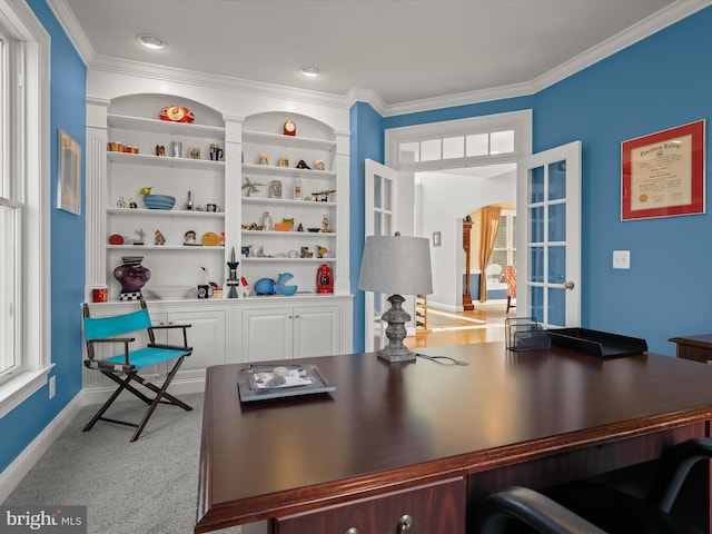 home office with arched walkways, light colored carpet, built in features, and ornamental molding