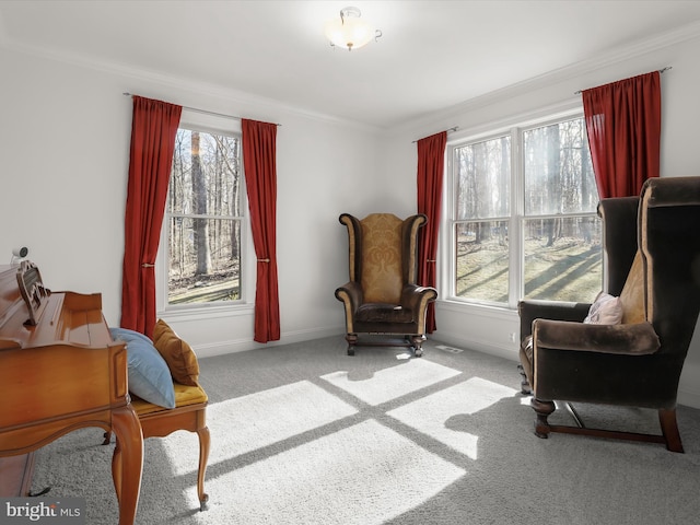 sitting room featuring light carpet, ornamental molding, and baseboards