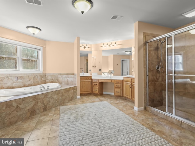 full bath with double vanity, a garden tub, a shower stall, and visible vents