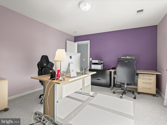 office with baseboards, visible vents, and light colored carpet