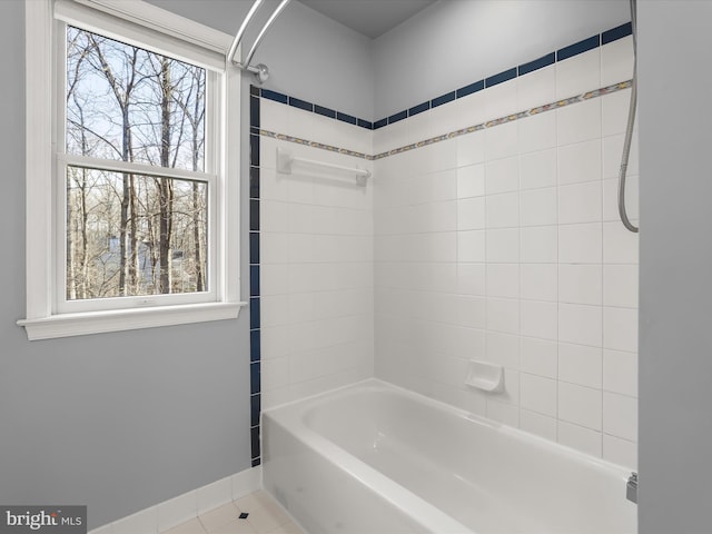 full bathroom with shower / bathtub combination, baseboards, a wealth of natural light, and tile patterned floors