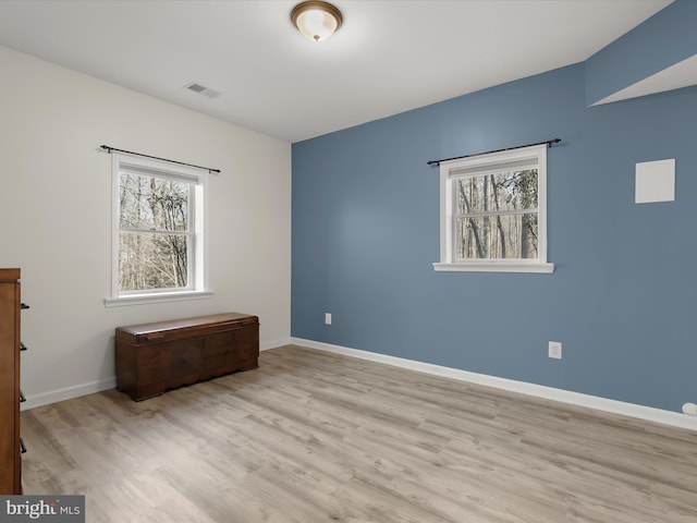 unfurnished bedroom featuring light wood-type flooring, visible vents, and baseboards