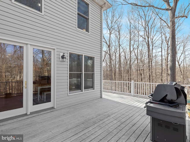 wooden deck featuring a grill