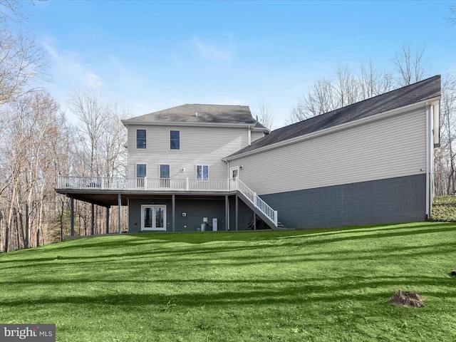 back of property featuring a wooden deck, stairway, a lawn, and french doors