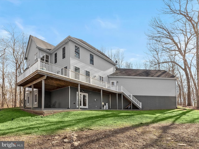 rear view of property with stairs, french doors, a lawn, a wooden deck, and a patio area