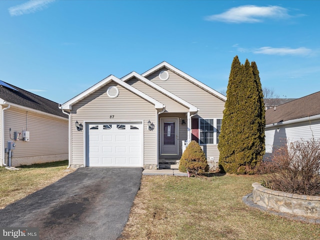 ranch-style home with a garage and a front yard