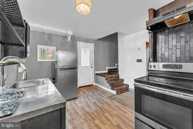 kitchen featuring light hardwood / wood-style floors, stainless steel appliances, ventilation hood, and sink