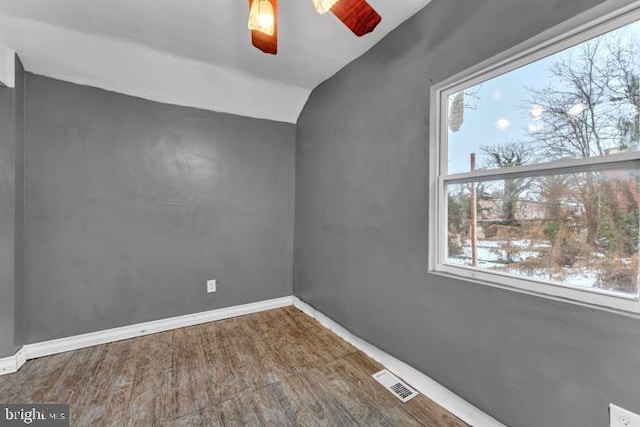 unfurnished room with ceiling fan, wood-type flooring, and lofted ceiling