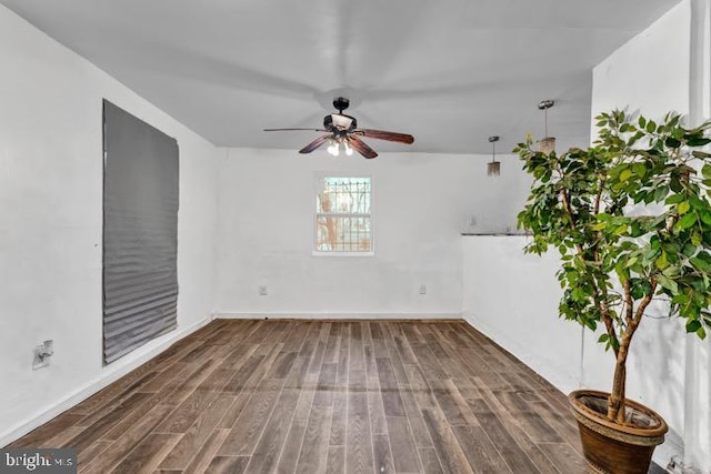 spare room with ceiling fan and dark hardwood / wood-style flooring