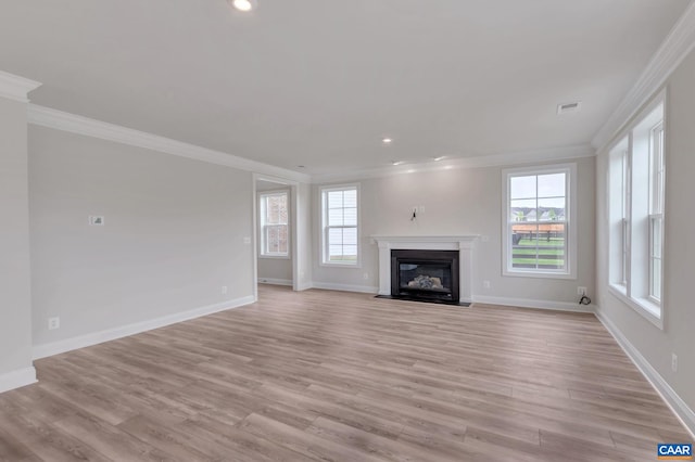 unfurnished living room featuring crown molding and light hardwood / wood-style flooring