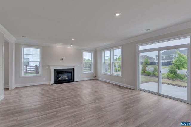 unfurnished living room featuring ornamental molding and light hardwood / wood-style floors