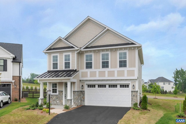 view of front of property featuring a front yard and a garage