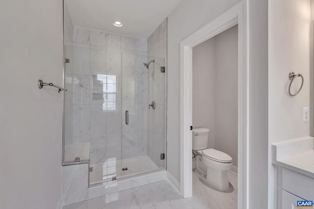 bathroom featuring vanity, an enclosed shower, and toilet