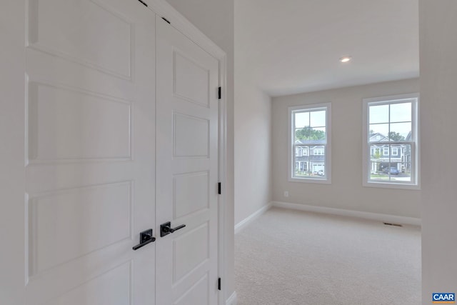 unfurnished bedroom featuring light carpet