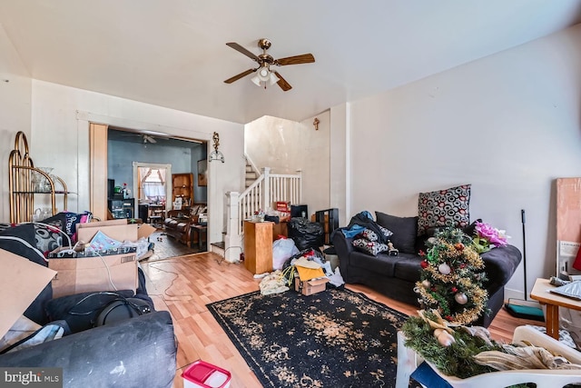 living room featuring hardwood / wood-style floors and ceiling fan