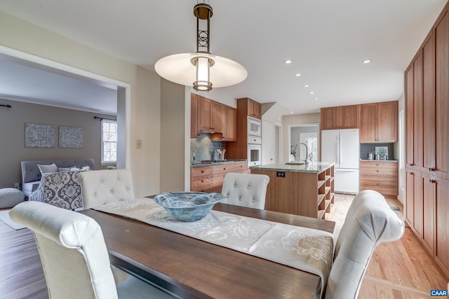 dining area featuring sink and light hardwood / wood-style floors