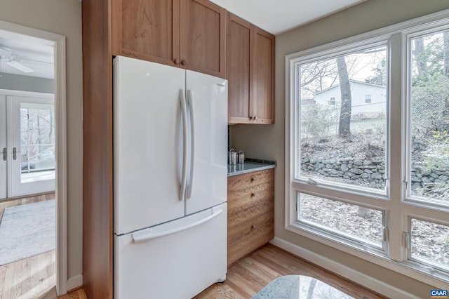 kitchen featuring white refrigerator, ceiling fan, french doors, and light wood-type flooring