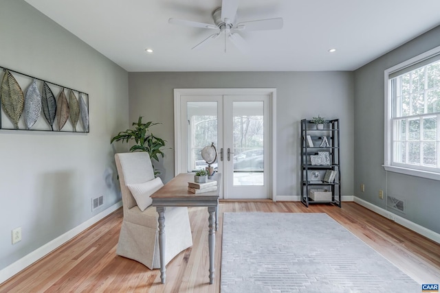 office with ceiling fan, light hardwood / wood-style floors, and french doors