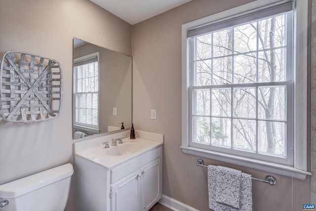 bathroom with vanity, plenty of natural light, and toilet