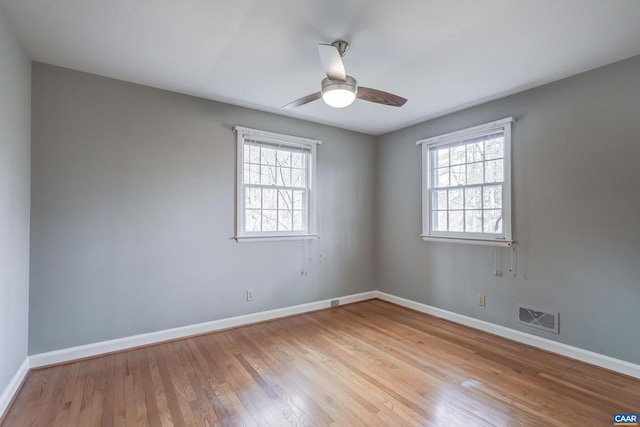 unfurnished room with ceiling fan and light wood-type flooring