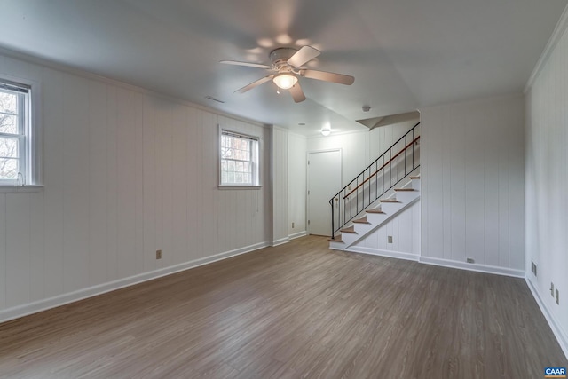 interior space with ceiling fan, ornamental molding, and hardwood / wood-style floors