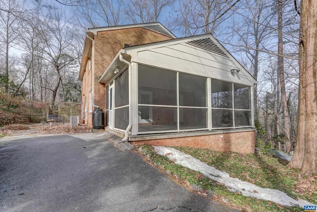 view of side of property with a sunroom