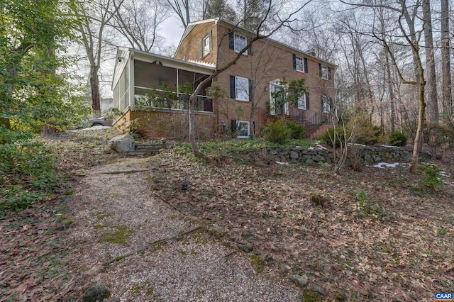 view of property exterior featuring a sunroom