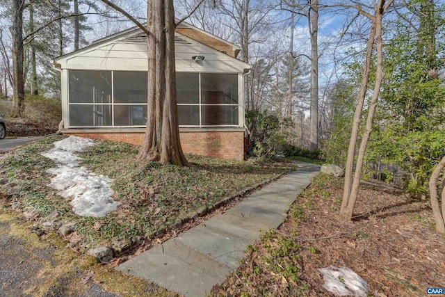 view of home's exterior with a sunroom