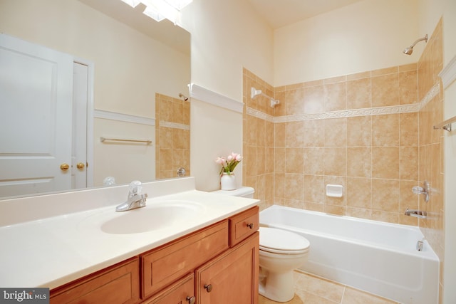 full bathroom featuring vanity, toilet, tiled shower / bath combo, and tile patterned flooring