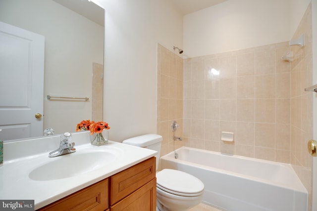 full bathroom with vanity, toilet, and tiled shower / bath