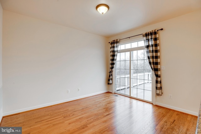 spare room featuring hardwood / wood-style floors