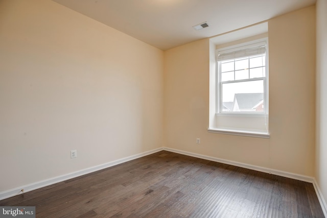 spare room featuring dark wood-type flooring