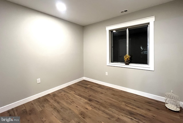 spare room featuring dark hardwood / wood-style flooring