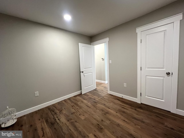 unfurnished bedroom with dark hardwood / wood-style floors