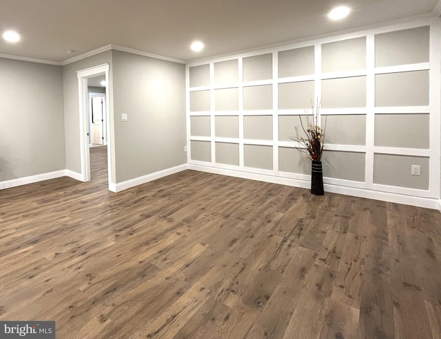 spare room with dark wood-type flooring and ornamental molding