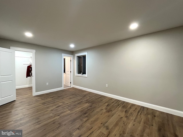 spare room with dark wood-type flooring