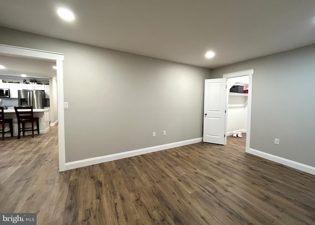 spare room featuring dark wood-type flooring