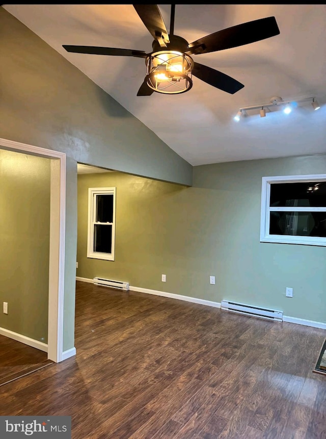 empty room with baseboard heating, lofted ceiling, and dark hardwood / wood-style floors