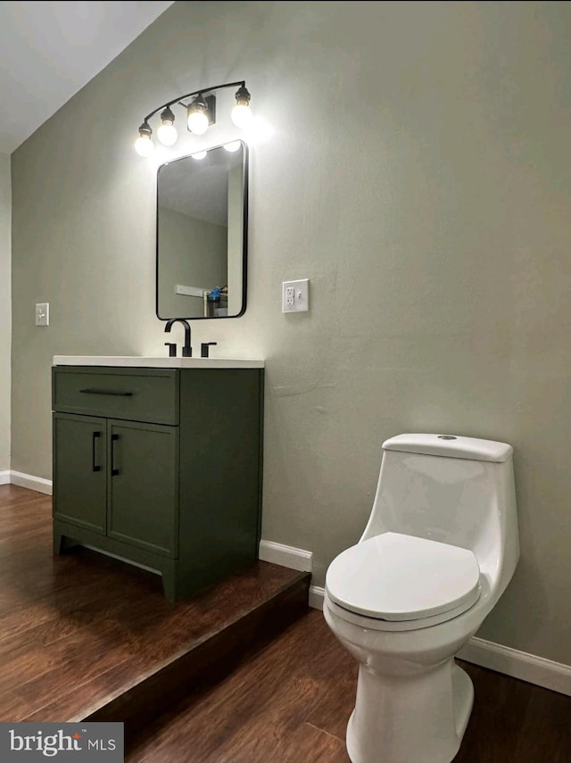 bathroom with vanity, hardwood / wood-style flooring, and toilet