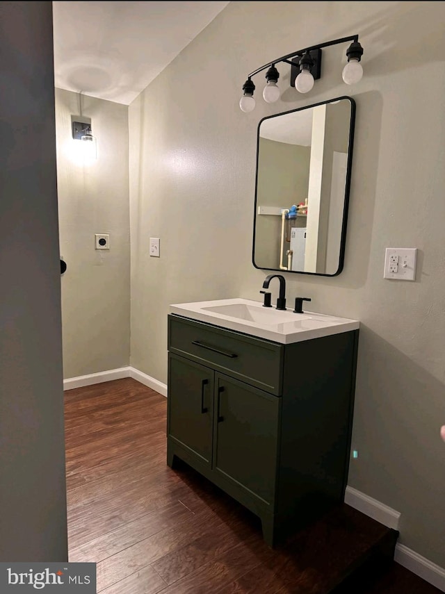 bathroom with hardwood / wood-style flooring and vanity