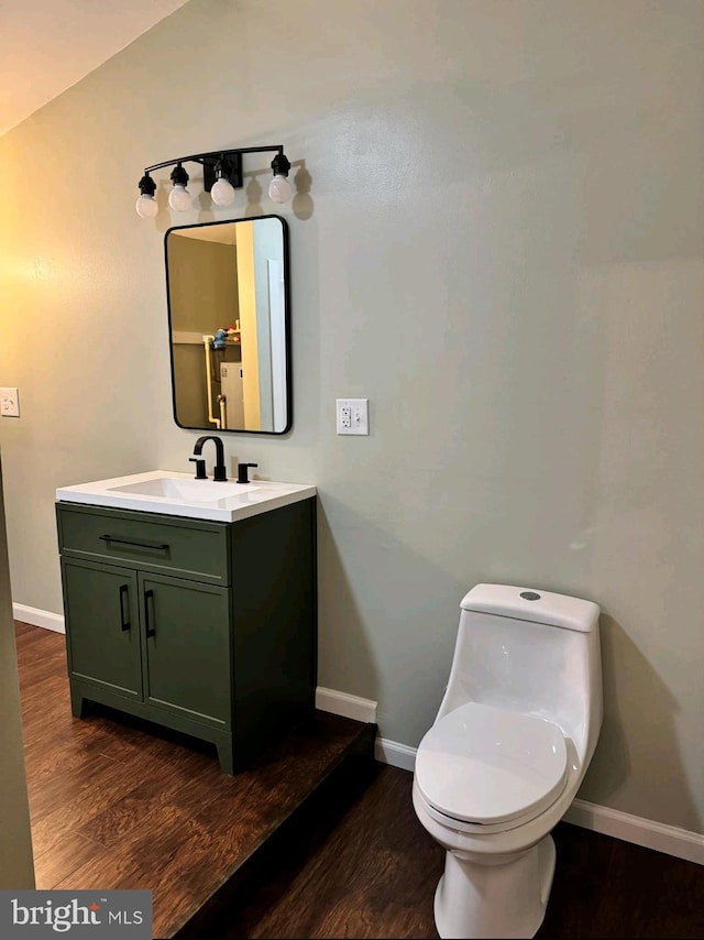 bathroom featuring hardwood / wood-style flooring, vanity, and toilet