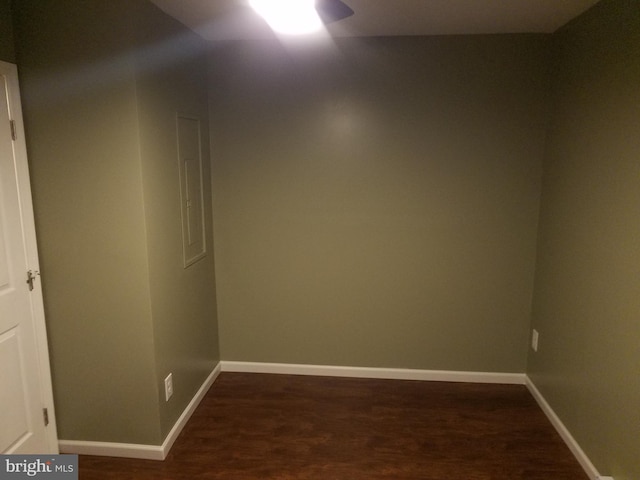 empty room featuring ceiling fan and dark hardwood / wood-style flooring