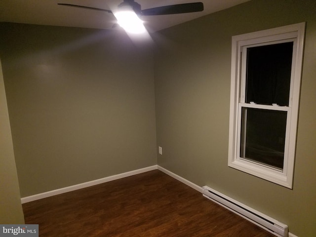 spare room featuring a baseboard heating unit, dark wood-type flooring, and ceiling fan