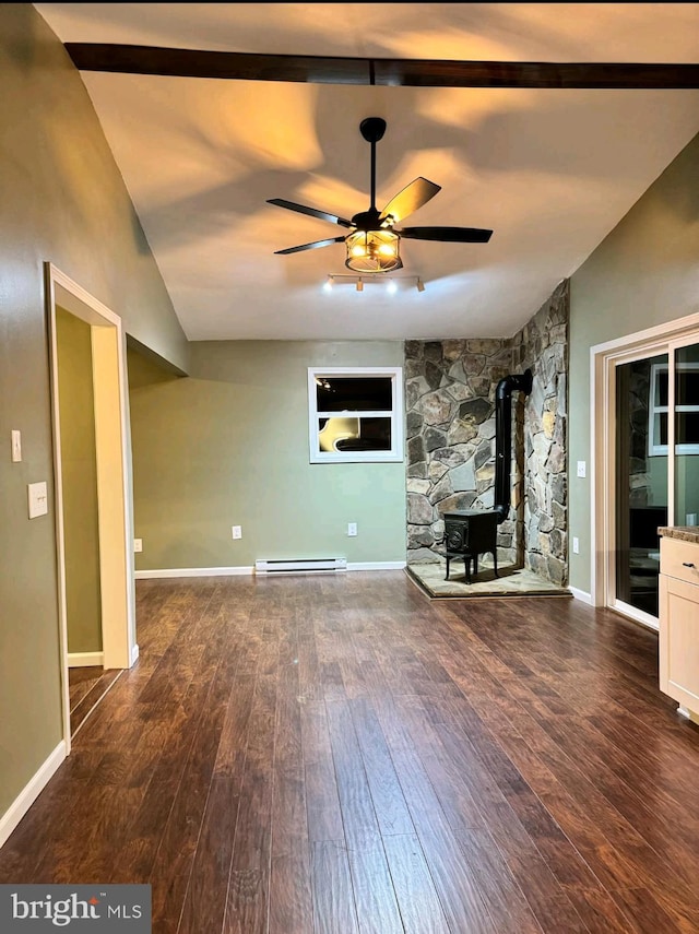 unfurnished living room with a baseboard heating unit, vaulted ceiling, a wood stove, and dark hardwood / wood-style flooring