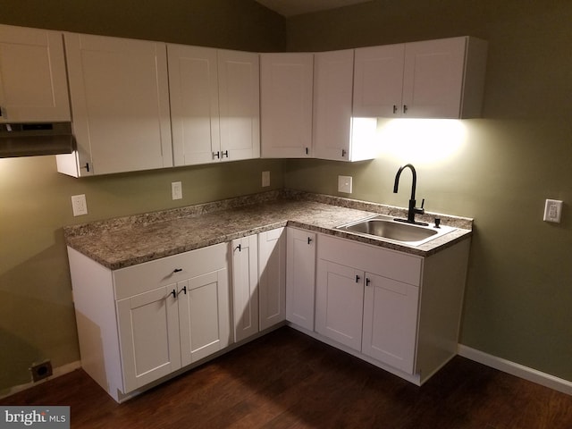 kitchen with white cabinetry, dark hardwood / wood-style floors, and sink