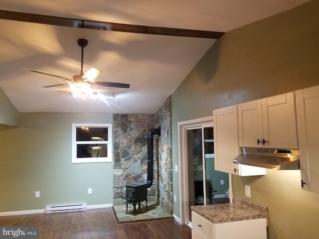 kitchen with white cabinetry, a baseboard heating unit, dark hardwood / wood-style floors, vaulted ceiling, and a wood stove